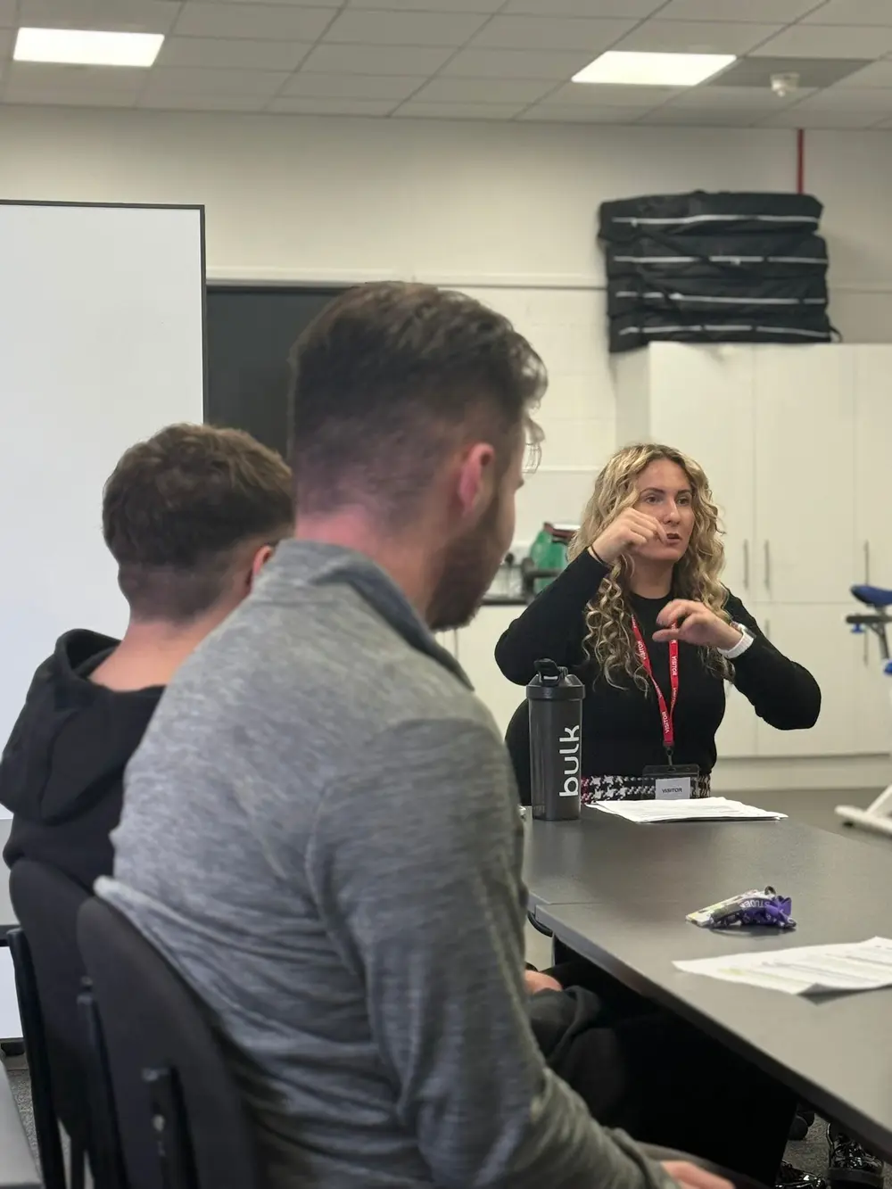Klaudia teaching British Sign Language to a small group of adult learners